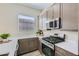 Stylish kitchen with stainless steel appliances, quartz countertops, and ample cabinet space at 3752 E Terrel St, San Tan Valley, AZ 85143