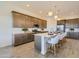Modern kitchen featuring an island with seating, stainless steel appliances, and ample counter space at 3752 E Terrel St, San Tan Valley, AZ 85143