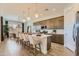 Bright, modern kitchen with island seating and stainless appliances open to a dining area at 3752 E Terrel St, San Tan Valley, AZ 85143