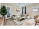 Inviting living room with a large sectional sofa, stylish decor, and an abundance of natural light at 3752 E Terrel St, San Tan Valley, AZ 85143