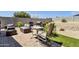 Backyard seating area with brick pavers, desert landscaping, outdoor kitchen and privacy wall at 3806 N 23Rd Ave, Phoenix, AZ 85015