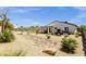 Large backyard featuring desert landscaping, covered patio, outdoor kitchen, and putting green at 3806 N 23Rd Ave, Phoenix, AZ 85015