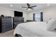 Comfortable bedroom with a large bed, dresser, ceiling fan, and neutral decor at 3806 N 23Rd Ave, Phoenix, AZ 85015
