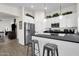 Bright kitchen featuring white cabinets, stainless steel appliances, and a breakfast bar with seating at 3806 N 23Rd Ave, Phoenix, AZ 85015