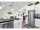 Modern kitchen with stainless steel appliances and a view of the dining and living areas at 3806 N 23Rd Ave, Phoenix, AZ 85015