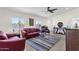 A spacious living room with hardwood floors, modern furniture, ceiling fan, natural light, and comfortable seating at 3806 N 23Rd Ave, Phoenix, AZ 85015