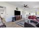 A spacious living room with hardwood floors, modern furniture, ceiling fan, and an open plan design at 3806 N 23Rd Ave, Phoenix, AZ 85015