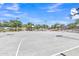 Outdoor community basketball court with hoops, lights and mature trees at 40061 W Novak Ln, Maricopa, AZ 85138