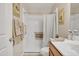 Bathroom with a white sink, light wood cabinets, shower and decorative towels at 40061 W Novak Ln, Maricopa, AZ 85138