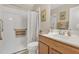 Bathroom with a shower, white sink, light wood cabinets and neutral tones at 40061 W Novak Ln, Maricopa, AZ 85138
