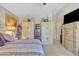 Bedroom with decorative storage cabinets, ceiling fan and large window at 40061 W Novak Ln, Maricopa, AZ 85138