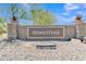 Community entrance featuring a stone sign with the name Homestead and desert landscaping at 40061 W Novak Ln, Maricopa, AZ 85138