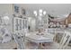 A well-decorated dining area showing the white dining set, chandelier, and decor next to the kitchen at 40061 W Novak Ln, Maricopa, AZ 85138