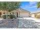 Charming single-story home with a well-maintained yard, desert landscaping, and a spacious driveway at 40061 W Novak Ln, Maricopa, AZ 85138