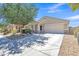 Charming single-story home with a well-maintained yard, desert landscaping, and a spacious driveway at 40061 W Novak Ln, Maricopa, AZ 85138