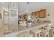 Open kitchen features granite countertops, bar seating, and stainless steel appliances at 40061 W Novak Ln, Maricopa, AZ 85138