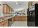 Bright kitchen featuring wood cabinets, granite countertops, and open access to the rest of the house at 40061 W Novak Ln, Maricopa, AZ 85138