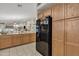 Kitchen boasts wood cabinets and a black refrigerator that seamlessly blends with the stylish design at 40061 W Novak Ln, Maricopa, AZ 85138