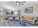 Open living room features neutral walls, light floors and is open to the kitchen at 40061 W Novak Ln, Maricopa, AZ 85138