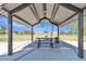 Covered community picnic table with nearby barbecue and trash receptacle at 40061 W Novak Ln, Maricopa, AZ 85138
