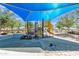 Community playground with climbing structure, slides, toys and shade at 40061 W Novak Ln, Maricopa, AZ 85138