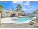 Inviting backyard with a sparkling pool, lounge area, and well-maintained landscaping at 40061 W Novak Ln, Maricopa, AZ 85138