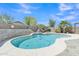 Beautiful backyard pool area with a waterfall feature, patio, and mature landscaping at 40061 W Novak Ln, Maricopa, AZ 85138