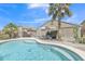 Sparkling backyard pool with rock landscaping, desert plants and an outdoor dining area at 40061 W Novak Ln, Maricopa, AZ 85138