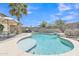 Backyard swimming pool with a beach entry, stone accents, and a built-in barbecue area at 40061 W Novak Ln, Maricopa, AZ 85138