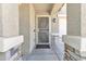 Inviting front porch featuring stone accents and a secure screen door entry at 40061 W Novak Ln, Maricopa, AZ 85138