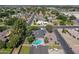 Aerial view of a single Gathering home with a pool, solar panels and lush landscaping in a residential neighborhood at 405 E Stanford Ave, Gilbert, AZ 85234