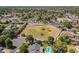 Wide aerial view showing a horse property complete with spacious grounds, lush trees, and more at 405 E Stanford Ave, Gilbert, AZ 85234