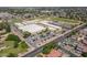 Aerial shot of school building surrounded by parking lots, athletic fields, and mature trees in an established neighborhood at 405 E Stanford Ave, Gilbert, AZ 85234