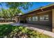 Large, green backyard featuring a covered patio, brick accents, and ample space for outdoor activities at 405 E Stanford Ave, Gilbert, AZ 85234