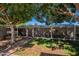 View of backyard chicken coops surrounded by mature trees, offering a unique outdoor feature at 405 E Stanford Ave, Gilbert, AZ 85234