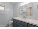 Bathroom featuring a vanity with blue cabinets, white quartz countertop, new fixtures and a window at 405 E Stanford Ave, Gilbert, AZ 85234