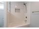 Updated bathtub with white subway tile, pebble floor and niche, and new fixtures at 405 E Stanford Ave, Gilbert, AZ 85234