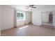 Bright bedroom with light wood floors, closet, and window at 405 E Stanford Ave, Gilbert, AZ 85234