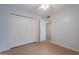 Bedroom with closet and ceiling fan, light colored flooring and light colored walls at 405 E Stanford Ave, Gilbert, AZ 85234