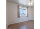Bedroom featuring light walls, light colored flooring, a window and neutral colored curtains at 405 E Stanford Ave, Gilbert, AZ 85234
