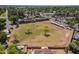 Aerial view of horse property featuring a large riding area with mature trees and perimeter fencing at 405 E Stanford Ave, Gilbert, AZ 85234