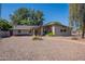 Single-story brick home with a well-manicured, low-maintenance gravel yard at 405 E Stanford Ave, Gilbert, AZ 85234