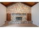 Close up view of the living room stone fireplace with wood storage cabinets at 405 E Stanford Ave, Gilbert, AZ 85234