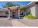 Close-up of the brick home's entrance, showing covered porch and tidy landscaping at 405 E Stanford Ave, Gilbert, AZ 85234