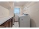 Laundry room features white appliances, tile floors, and wood cabinets at 405 E Stanford Ave, Gilbert, AZ 85234
