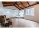 Spacious living room with wood paneled vaulted ceiling and open layout to other rooms at 405 E Stanford Ave, Gilbert, AZ 85234