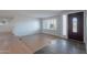 Bright and airy living room with wood floors and a modern front door at 405 E Stanford Ave, Gilbert, AZ 85234