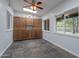 Well-lit living area with tile flooring, built-in cabinets, and large windows overlooking the yard at 405 E Stanford Ave, Gilbert, AZ 85234