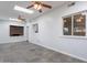 Well-lit living room featuring tile floors, ceiling fans, and large windows at 405 E Stanford Ave, Gilbert, AZ 85234