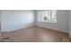 Bright living room featuring a large window, wood floors, and neutral decor at 405 E Stanford Ave, Gilbert, AZ 85234